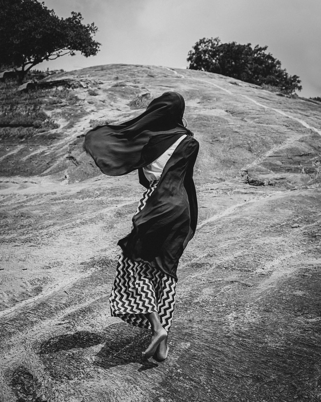 Grayscale photo of a woman in pursuit